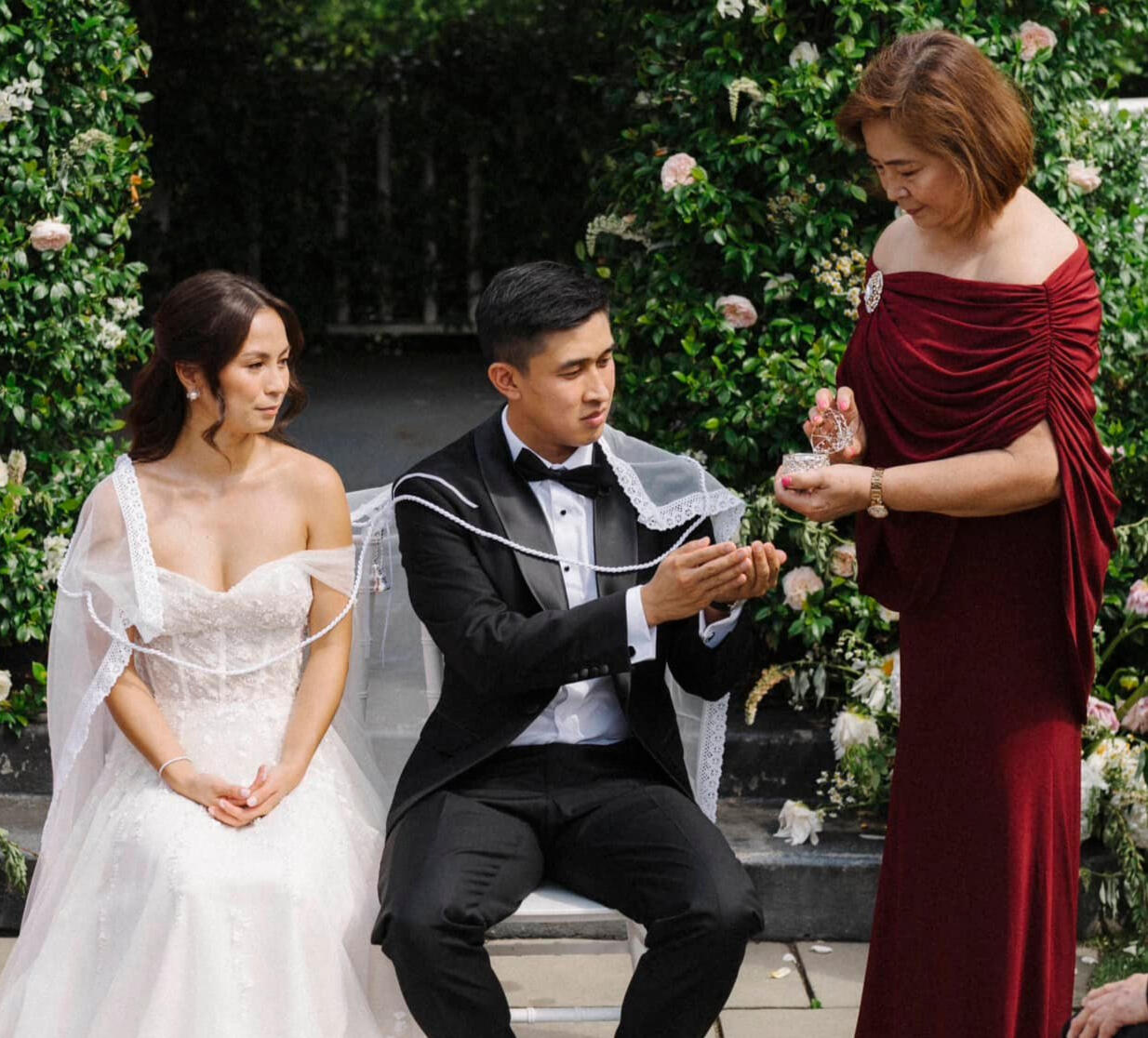 Beautiful wedding couple participating in an asian ceremony ritual